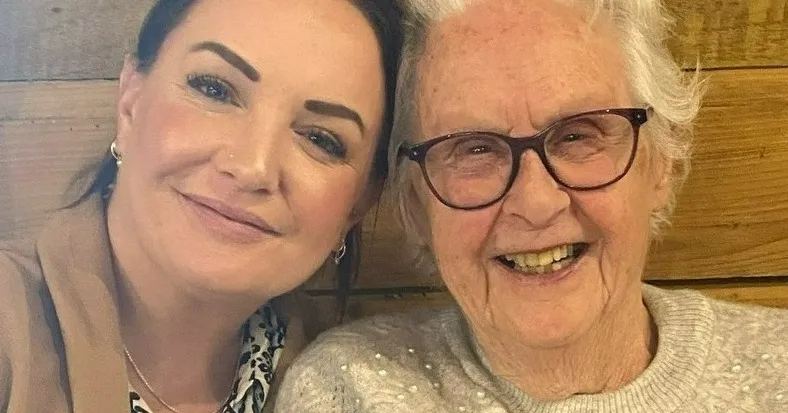 A woman taking a selfie with an older woman.