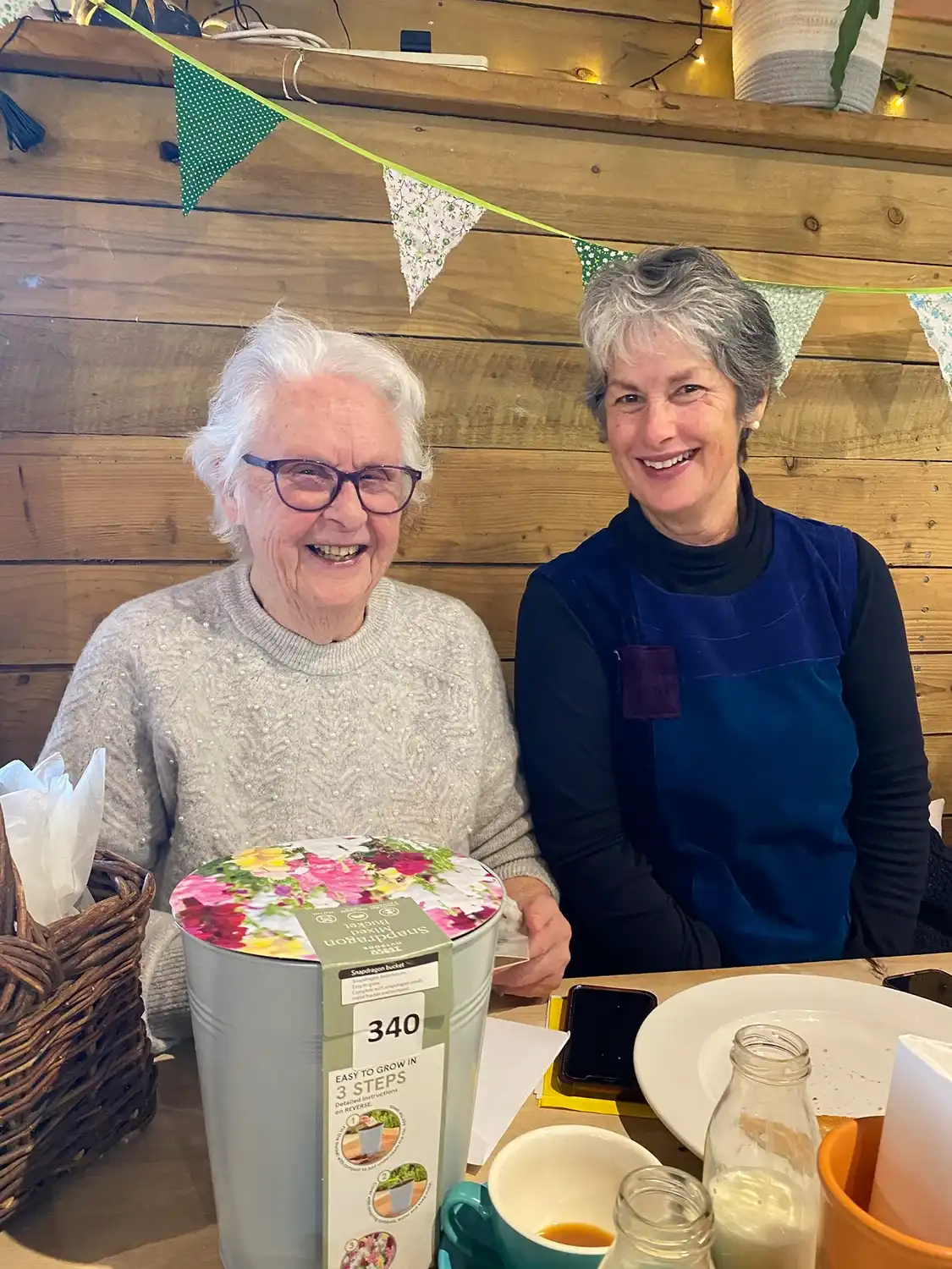 A couple of women sitting at a table.