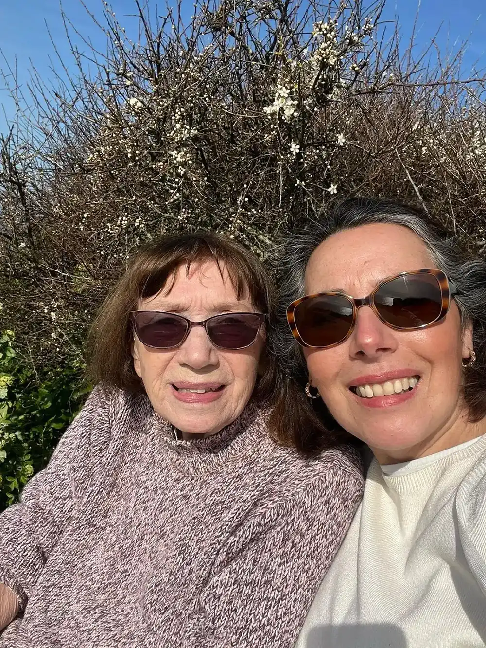 A couple of women sitting next to each other.